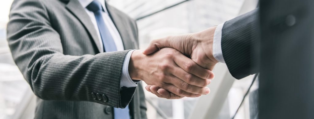 A close up of two businessmen shaking hands