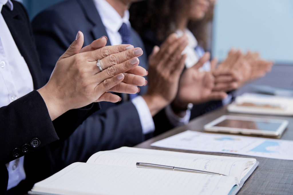 People clapping at a successful conference