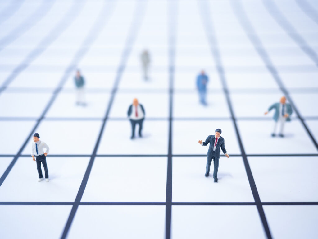 Miniatures of people social distancing at an exhibition center
