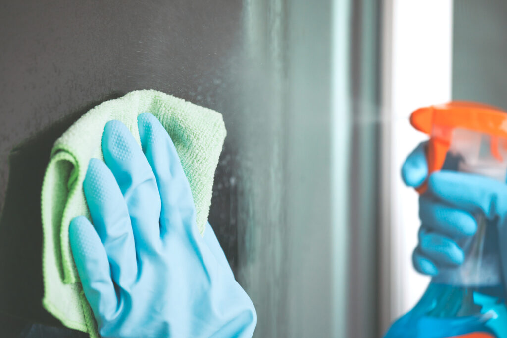 A person cleaning conference room windows