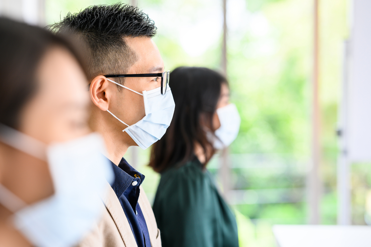 People at a meeting wearing face masks