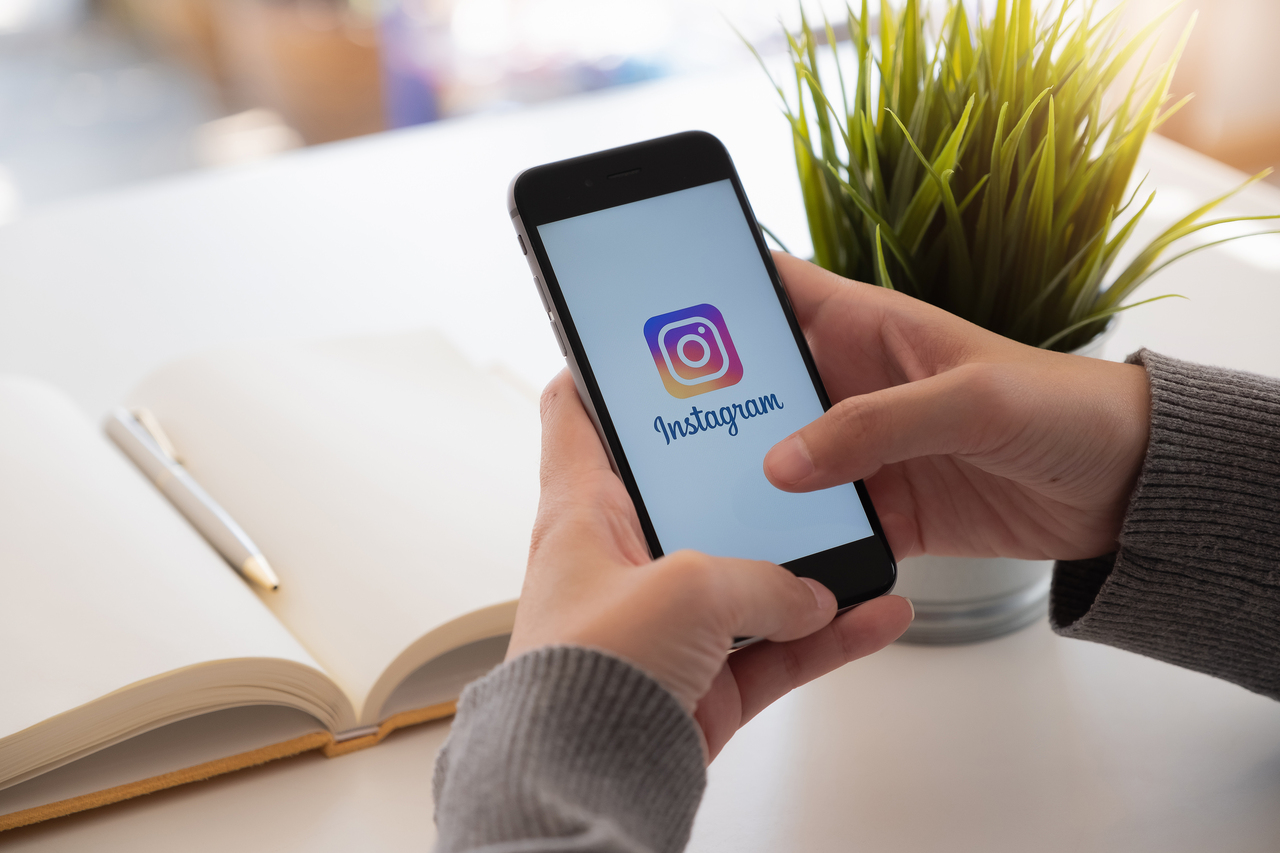 A person uploading event promotions on Instagram