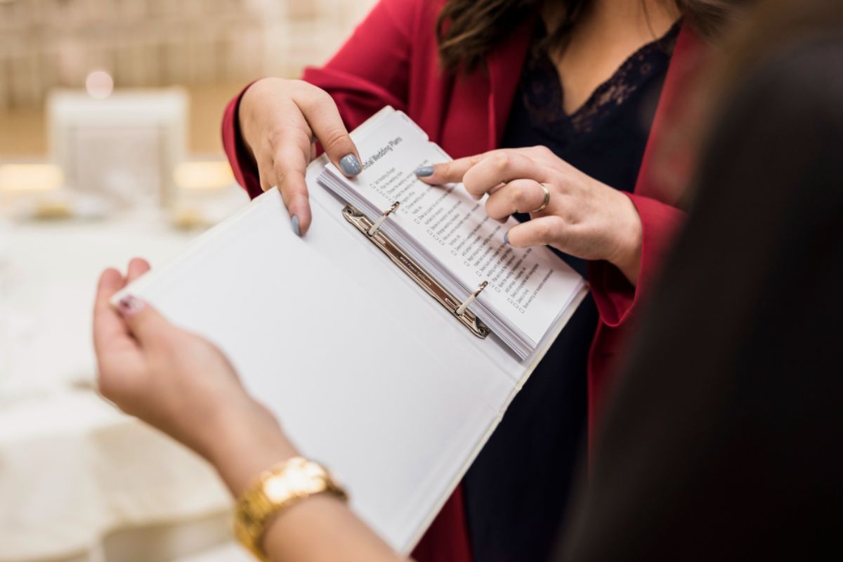 An event planner guiding  their staff on a checklist for an event in an exhibition hall