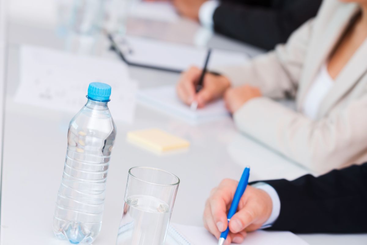 Professionals taking notes during a keynote speech during an international conference