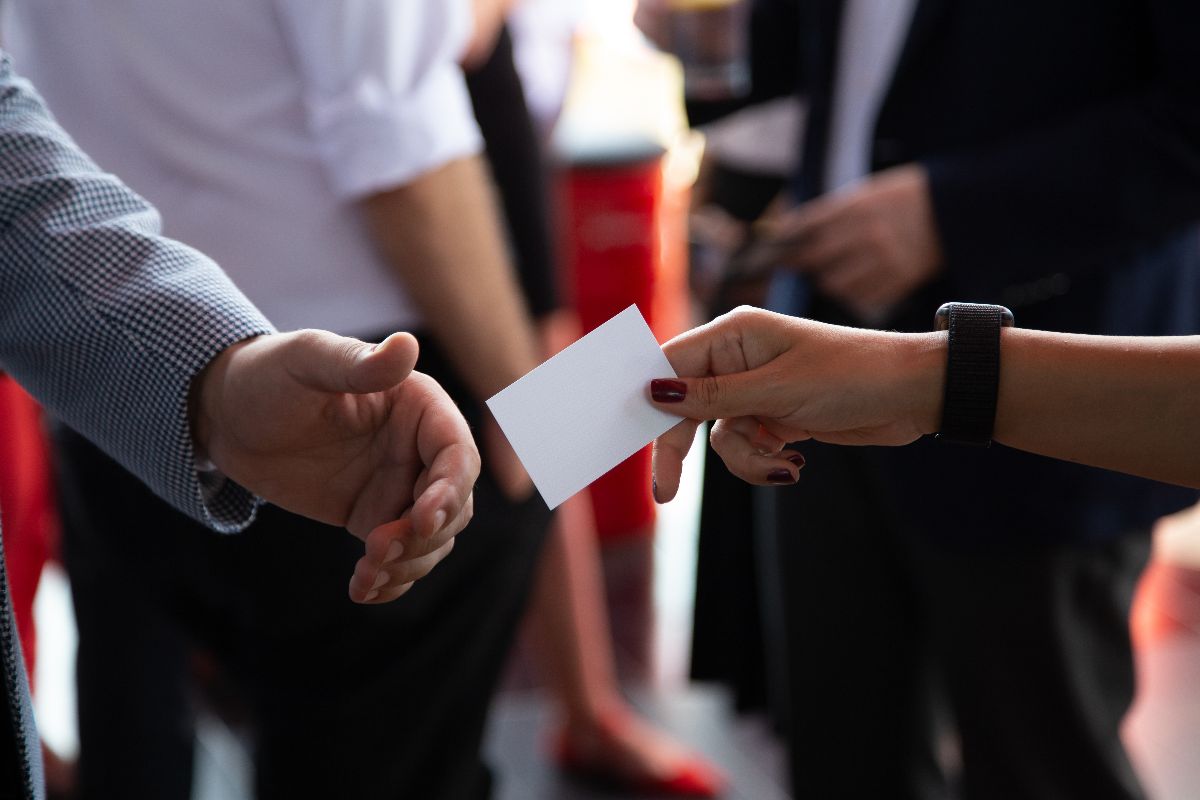 Two profesionals exchanging calling cards during a trade show in Manila