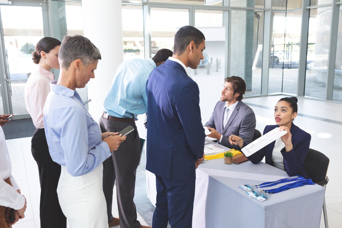 Business men signing up at registration during a trad expo